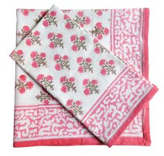 three napkins with pink flowers on them