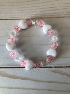 This is a Valentine Heart Bracelet. It would make a cute gift for a little girl for Valentines Day. It would make a cute gift for a little girl's Birthday. It has five heart beads. It has pink and clear 8mm faceted beads. It was made with.8mm sturdy stretch string. It fits girls ages 5-8. It stretches to fit on the wrist. All items are ready to be shipped I do combined shipping. Items ship in 2-5 business days. Check out more items at: http://www.etsy.com/shop/MesheleCrafts  https://www.facebook Bracelets Kids, Girls Bracelets, Valentines Bracelets, Bracelet Heart, Kids Bracelets, Bracelet Beaded, Heart Beads, Plastic Beads, Valentine Heart