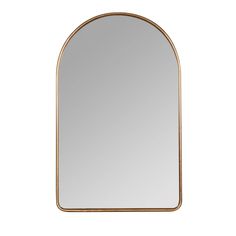 an arched mirror with gold trim on the edges and a white wall in the background