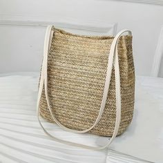 Carry Summer Wherever You Go Introducing our Bohemian Straw Woven Shoulder Bag, your new favorite summer accessory that combines effortless style with functional design. Perfect for beach getaways, sunny market days, or any casual outing, this handcrafted bag is as versatile as it is beautiful, ensuring you carry a piece of summer with you wherever you go. Key Features High-Quality Straw Material: Meticulously woven from the finest straw, this bag offers durability while staying lightweight, making it ideal for all-day wear. Compact Yet Spacious: With dimensions of 25*25*12 cm, it provides ample space for your essentials without being bulky. Secure Hasp Closure: Keeps your belongings safe with an easy-to-use hasp closure that adds an elegant touch to the bag's overall design. Benefits of O Bohemian Shoulder Bag For Spring Travel, Casual Woven Beach Bag For Daily Use, Casual Jute Bucket Bag For Spring, Bohemian Large Capacity Shoulder Bag For Spring, Casual Beige Woven Bucket Bag, Casual Spring Jute Bucket Bag, Spring Bohemian Hobo Bag In Natural Color, Beige Hobo Shoulder Bag For Beach, Trendy Beige Bucket Bag For Beach