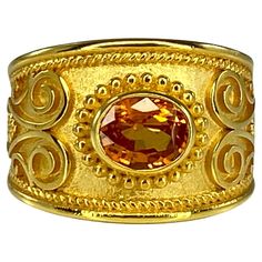 Presenting S.Georgios designer 18 Karat Solid Yellow Gold Ring all handmade with the Byzantine Style workmanship and a unique velvet background decorated with natural oval cut 1.52 Carat Orange Sapphire. All the granulated decorations of this ring are added by hand as well as the unique Byzantine background. This gorgeous piece can be also ordered in all White, or Rose Gold, and with different center stone. please contact us. The ring is outstanding in the quality of workmanship and stone collec Orange Sapphire Ring, Velvet Background, Orange Ring, Orange Sapphire, Bagan, Stone Collection, Yellow Gold Ring, Solid Yellow, Yellow Gold Rings