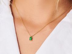 A dainty stone and delicate metallic chain are combined to create this Gold Pendant Necklace in bright emerald, your new favorite wear-anywhere accessory. Emerald is the birthstone of May. High quality lab created emerald stone Made of 14K gold plated sterling silver Pendant size: 10mm x 6mm with 16" chain Hypoallergenic, nickel and lead free Tarnish resistant Silver Emerald Pendant Necklace, May Birthstone Necklace With Clavicle Chain, Delicate Green Necklace With May Birthstone, Everyday Fine Jewelry Green Necklaces, Everyday Fine Jewelry Green Necklace, Delicate Green May Birthstone Necklace, Green Fine Jewelry Necklace For Everyday, Green Minimalist Birthstone Necklace, Emerald Gemstone Necklace For May Birthstone