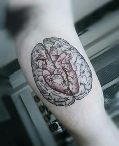 a person's arm with a tattoo on it that has a drawing of a brain