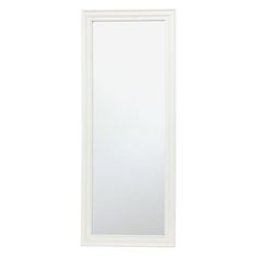 a white mirror sitting on top of a wall