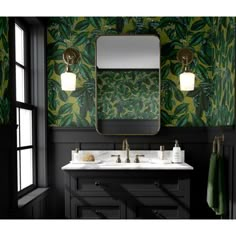 a bathroom with green and gold wallpaper, two sinks and a mirror on the wall