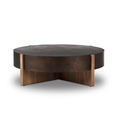 a round coffee table with wooden legs and a black top, on a white background