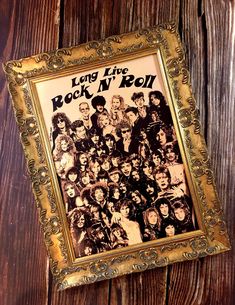 an old photo frame with the band's poster in it on a wooden wall