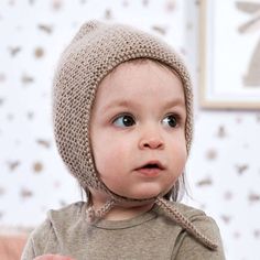 a small child wearing a knitted hat