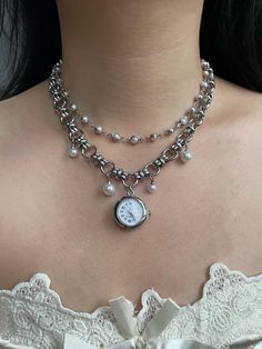 This vintage-inspired silver watch necklace choker combines elegance with a touch of grunge. Featuring a delicate pearl-adorned watch and a sleek silver chain, it's a unique Y2K-style accessory that adds a timeless charm to any outfit. Perfect as a statement piece for special occasions or as a thoughtful and distinctive wedding gift. - The watch is functional - Material: Titanium alloy pendant chain - Necklace length: 36cm + 6cm extension chain - Free shipping - Handcrafted, custom sizes available upon request - Packaged in a beautifully designed gift box, perfect for gifting - Order processing time: 3-5 days Watch Necklace Choker, Vintage Silver Watch, Watch Choker, Necklace Grunge, Clock Necklace, Pearl Watch, Choker Necklace Silver, Grunge Jewelry, Necklace Chain Lengths