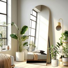 a mirror sitting on top of a wooden floor next to plants