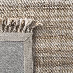 a close up view of the side of a rug with fringes on top and bottom