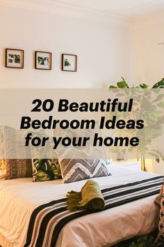 a bedroom with white walls and green plants on the bed