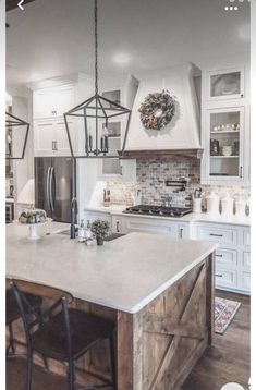 a kitchen with white cabinets and an island