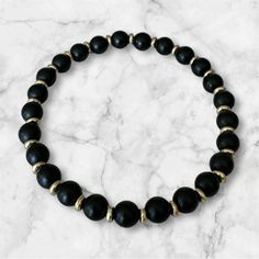 Indulge in a touch of luxury with our Black Onyx Gemstone Bead Stretch Bracelet. This elegant bracelet features beautifully smooth and polished black onyx gemstone beads, creating a timeless and sophisticated look. Perfect for any occasion, this bracelet adds a touch of glamour and refinement to any outfit. Luxury Black Beads Bracelets, Elegant Polished Black Beads, Elegant Black Polished Beads, Onyx Crystal Bracelet With Black Round Beads, Elegant Adjustable Black Beads, Elegant Black Beaded Bracelets, Elegant Black Rosary Bracelet, Elegant Adjustable Stretch Bracelet With Natural Stones, Elegant Onyx Beaded Bracelets With Gemstone Beads