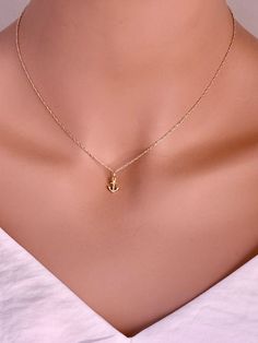 This 14-karat yellow gold anchor charm is set with one .003-ct. round white diamond (SI-I1 grade/G,H,I color; .003-ct) at the bottom anchor point. The charm is flat on the back and brightly finished on both sides. Inspirational Necklace You are Strong Necklace - Warrior Necklace - Survivor gift -Encouragement Gift -Tiny 14k solid gold anchor necklace Tiny 14k Real Gold Anchor Pendent from a delicate chain. Dainty little anchor necklace made of solid 14KT Yellow Gold on a delicate solid 14kt Yell Elegant Yellow Gold Anchor-shaped Necklaces, Gold Anchor Jewelry Gift, Anchor Shaped Charm Jewelry As Gift, 14k Gold Anchor Necklace Gift, 14k Gold Anchor Necklace As Gift, 14k Gold Anchor Shaped Jewelry Gift, Elegant Anchor-shaped Jewelry Gift, Gold Anchor Jewelry For Anniversary, Diamond Charm Necklace