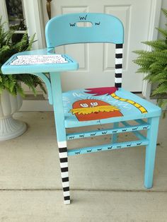 a blue chair with a cartoon character painted on it