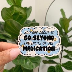 someone holding up a sticker that says you are about to go beyond the limits of my meditation