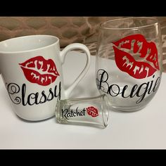 two glass mugs with red lips on them for $ 20 each, one has a sticker that says classy bougie and the other is $ 20