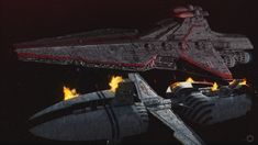 two star wars ships in the dark with flames coming out of them