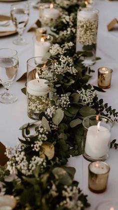 a long table with candles and flowers on it