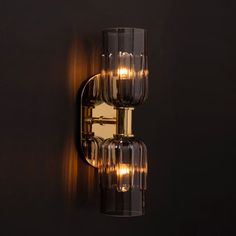 a wall light that is on the side of a wall with some lights in it