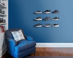 a blue chair sitting in front of a wall with shoes on it