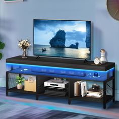 a flat screen tv sitting on top of a black entertainment center