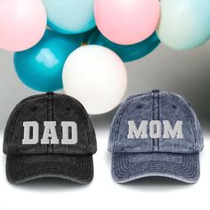 "If you're looking for a gift that's both unique and personal, look no further than the Mom & Dad Embroidered Dad Hat. This stylish cap is the perfect way to announce your pregnancy in style, and it also makes a great gift for new parents-to-be. The hat is made of high-quality materials, and features intricate varsity lettered embroidery work that reads \"Mom\" and \"Dad\". It's adjustable, so it can be worn by anyone, and its color scheme means it will go with any outfit. Whether you're looking for a gift for yourself or for someone else, the Mom & Dad Embroidered Dad Hat is sure to please. * 100% cotton twill * 6-panel unstructured cap with a low profile * 6 sewn eyelets * Black sweatband * Metal snap buckle with an antique brass finish * Washed-out vintage effect 📦 Shipping & Handling Personalized Cotton Birthday Hat, Father's Day Baseball Cap With Letter Print, Personalized Cotton Baseball Cap As A Gift, Personalized Cotton Baseball Cap As Gift, Cotton Dad Hat With Letter Print As Gift, Father's Day Gift Trucker Hat With Curved Brim, Letter Print Baseball Cap As A Gift, Adjustable Baseball Cap With Letter Print As Gift, Adjustable Letter Print Baseball Cap As Gift