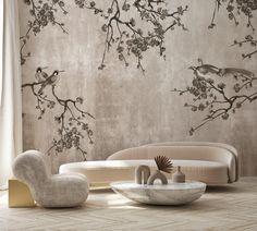 an elegant living room with birds and flowers on the wall