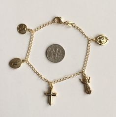 "18k gold filled charm (angel,guadalupe,cross,divine child ,milagrosa)bracelet for good luck and protection..7.5\" pulsera de angel,guadalupe,cruz,divino niño,milagrosa en 18k gold filled para proteccion y buena suerte.7.5\"" Spiritual Yellow Gold Charm Bracelet, Adjustable Gold Rosary Bracelet With Charms, Gold Spiritual Charm Bracelet With Dangling Charms, Gold Spiritual Charm Bracelet With Lobster Clasp, Nickel-free Gold Spiritual Charm Bracelet, Gold Nickel-free Spiritual Charm Bracelet, Spiritual Gold Rosary Bracelet For Blessing, Gold Spiritual Rosary Bracelet With Miraculous Medal, Gold Spiritual Rosary Bracelet With Charms