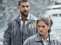 a man and woman standing next to each other in front of a rock formation with the words fbf written on it