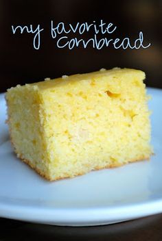 a piece of yellow cake sitting on top of a white plate with the words my favorite cornbread written above it