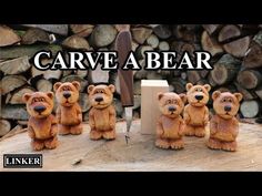 carved bear figurines sitting on top of a piece of wood