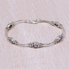 Five stones of purple amethyst stones totaling six carats sparkle side-by-side in this link bracelet, designed by Yus Swarmana of Indonesia. Handcrafted from sterling silver by local artisans, this elegant bracelet makes a stunning statement wherever it goes.