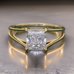 a gold ring with a princess cut diamond