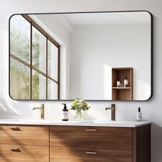 a bathroom vanity with a large mirror above it and flowers in the vase on the counter