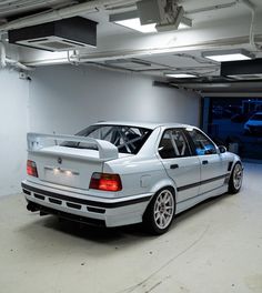 a white car is parked in a garage