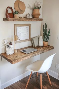 a wooden desk topped with a laptop computer sitting on top of a wooden shelf next to a white chair