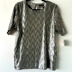 Vintage 80s/90s Deadstock Short Sleeve Silver Blouse By Notations. Size Medium. Original Tags Attached. 16” Shoulder To Shoulder 20” Armpit To Armpit. 26” Top To Bottom. Retro Spring Formal Tops, Retro Formal Spring Tops, Spring Retro Formal Tops, Vintage Short Sleeve Tops For Party, Retro Tops For Spring Night Out, Retro Tops For Night Out In Spring, Vintage Summer Blouse For Night Out, Silver Blouse, Petite Blouses