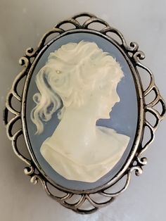 Very delicate blue and white cameo set in sterling silver. The material of the cameo is a type of resin. It is not cold to the touch. See photos for measurements.  Any questions or concerns please ask.  Check out my other shop Arlettemichelle just put my shop name in the etsy search bar all one word.  My son John's artwork Jmoriginalart or Jmoriginalart.com Victorian Blue Cameo Jewelry, Blue Cameo Jewelry For Formal Occasions, Formal Blue Cameo Jewelry, Wire Wall Basket, Silver Gift Wrap, Vintage Blue And White, Diamonds And Pearls, African Queen, Cameo Necklace