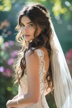 a beautiful woman in a wedding dress and veil