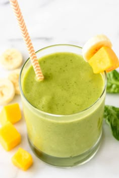 two glasses filled with green smoothie next to each other on a white counter top