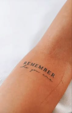 a person with a tattoo on their arm that says, remember you are brave in black ink