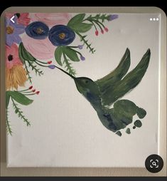 a painting of a hummingbird with flowers on it's back and green wings