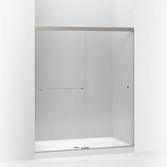 a white bathroom with a glass shower door and no curtain on the wall, in front of a mirror