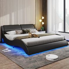 a bedroom with a large bed and blue lights on the headboard is pictured in this image