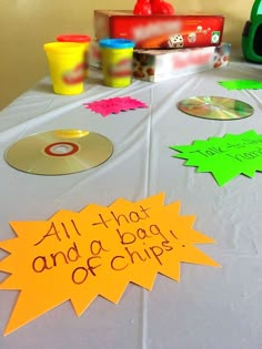 a table topped with lots of different types of cds