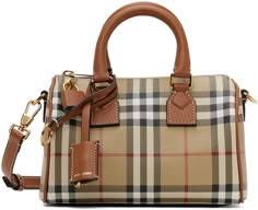 Find BURBERRY Mini Check Bowling Bag on Editorialist. The Burberry Mini Check Bowling Bag is crafted from pebble-grained leather with a signature check pattern and black burnished edges. The bag features twin rolled carry handles, a detachable strap with a keyring, a logo-stamped tag and sheathed key, an adjustable and detachable shoulder strap, a leather-covered padlock, a zip closure, twill lining, and a H6 x W7.5 x D4.25 dimension. Vintage Tokyo, Mini Bowling, Dream Bag, Purse Essentials, Handbag Essentials, Bowling Bag, Buckle Bags, Dream Aesthetic, Dream Bags