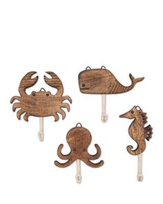 four wooden sea animals on toothpicks in the shape of an octopus, crab and whale