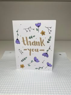 a thank you card with flowers and leaves on the front that says, thank you